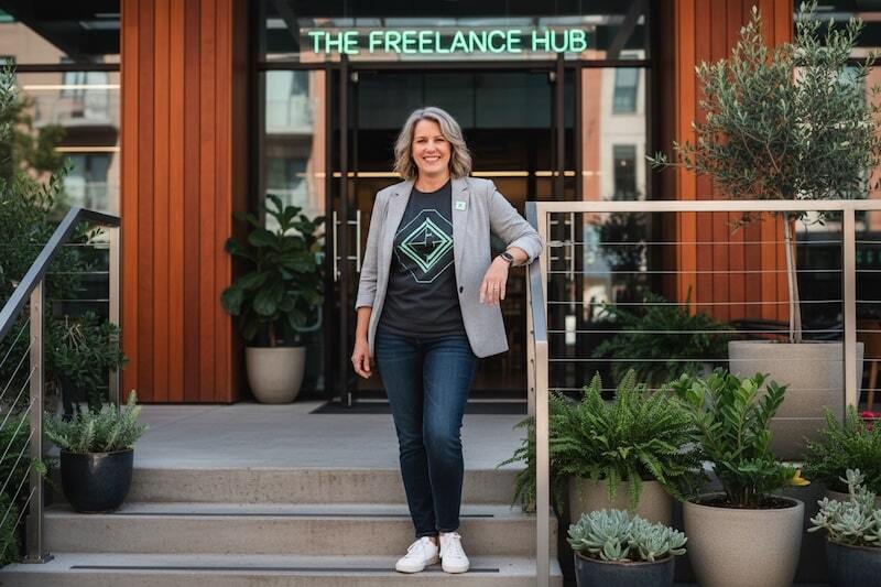 Woman S Corp owner stands in front of their business