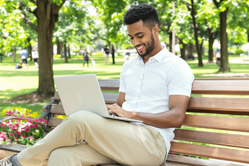 A man working at a park bench