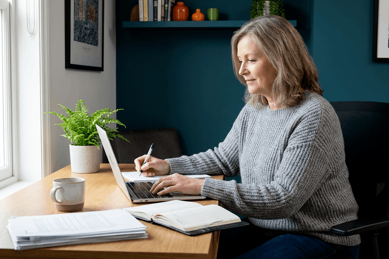 Real estate agent taking notes on her laptop