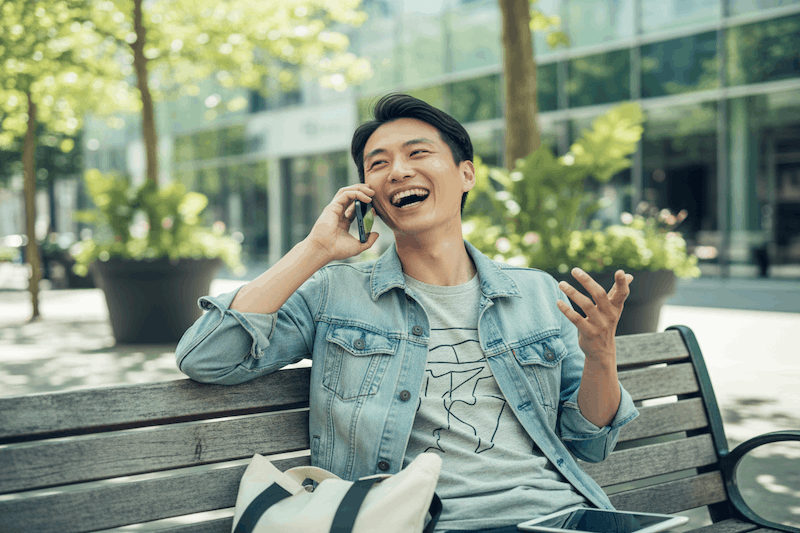 man on the phone at park bench